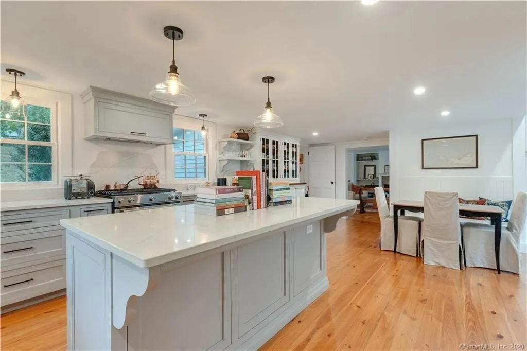 White inset kitchen in Essex CT with island, pendant lights and quartz countertops