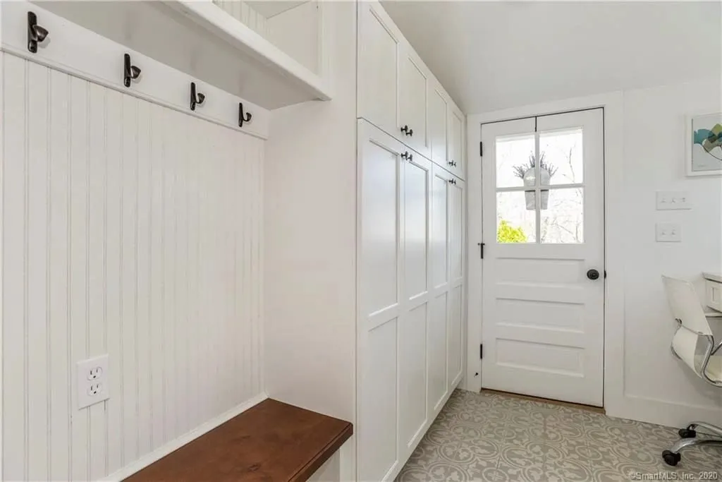 Mudroom storage wall with cubbies and coat hooks in Essex CT