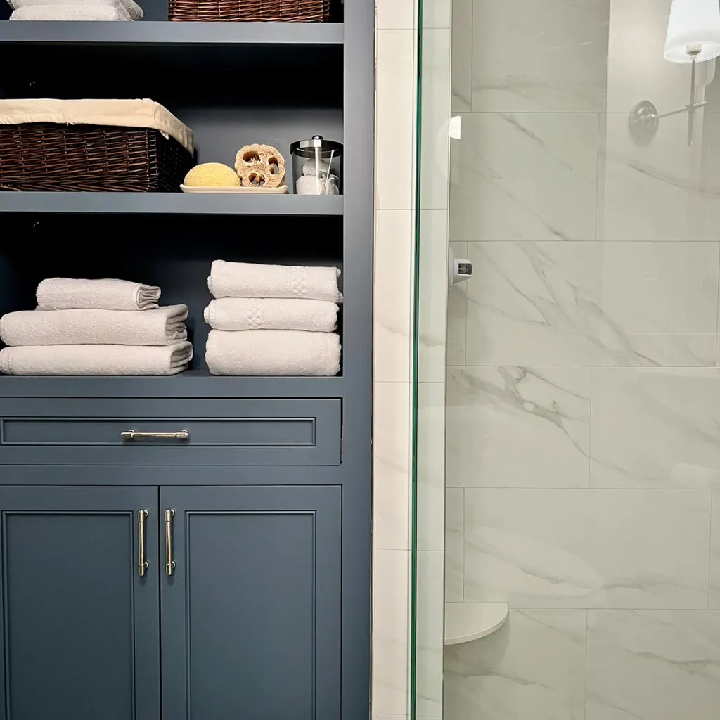 Primary bathroom in Essex CT with white vanity cabinets and quartz countertop by Pondside