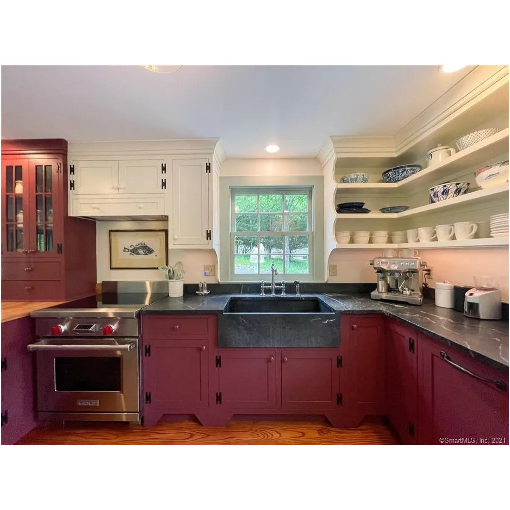 Traditional Essex CT kitchen with red shaker cabinets, soapstone countertops and farmhouse sink